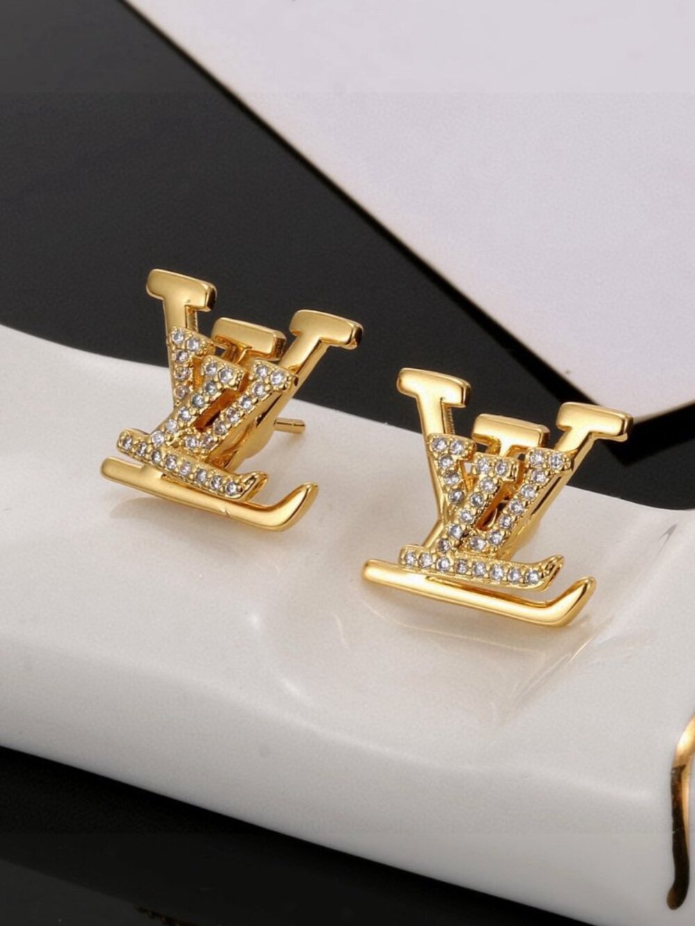 Delicate exquisite gold‑toned earrings with sparkling diamond accents